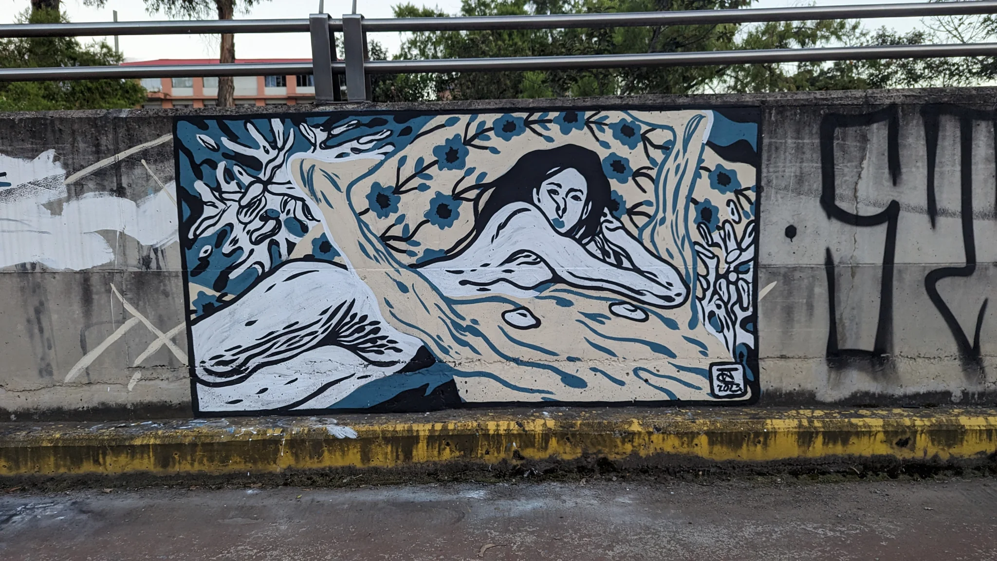 Un mural de un pez azul bajo una baranda