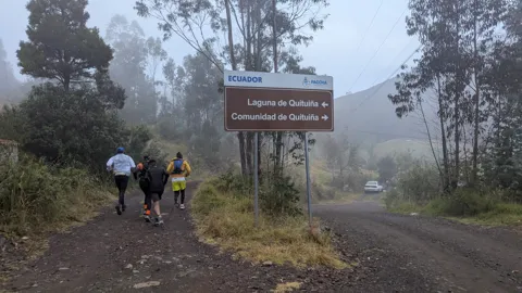 Un letrero de sendero en la neblina